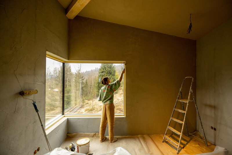 A woman paints walls in home renovation process