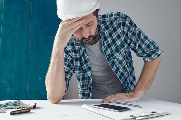 construction worker looking at notes