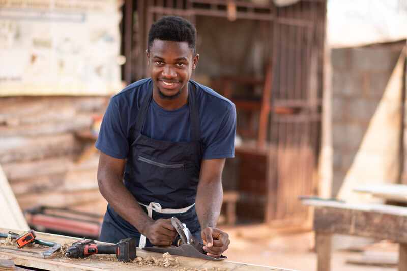 Young African American carpenter smiling while working