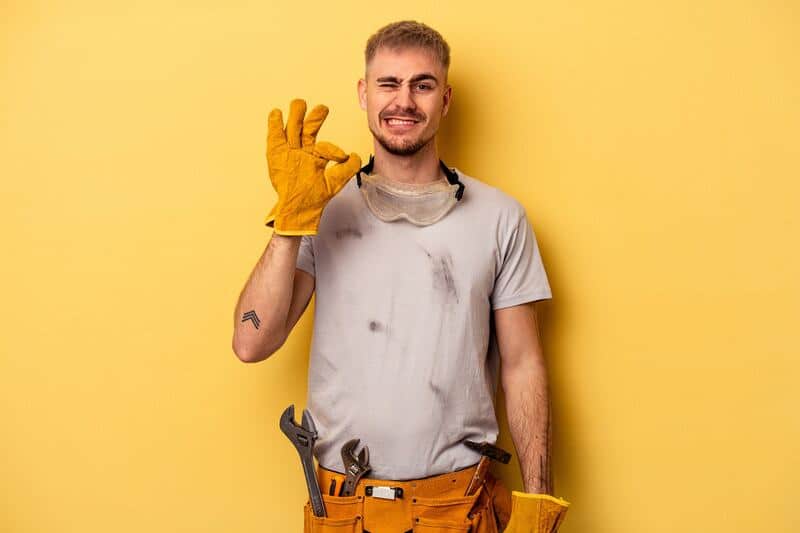 Young carpenter confident showing ok gesture