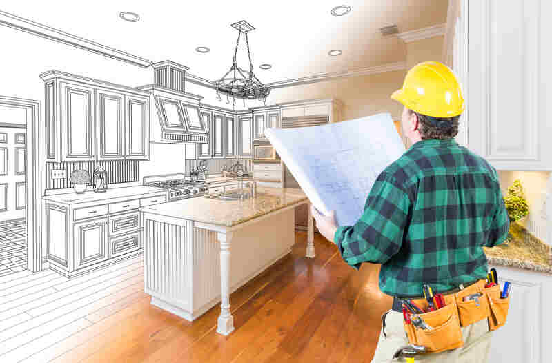 Male Contractor with Hard Hat and Plans Looking At Custom Kitchen Drawing Photo Combination